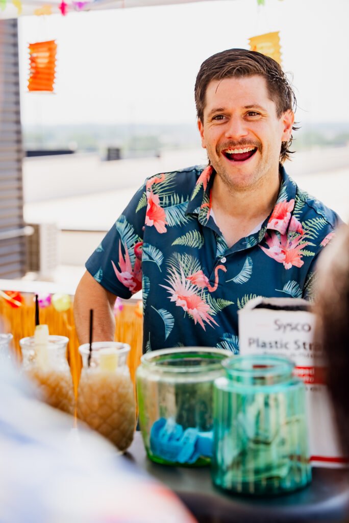 Tom smiling behind the bar